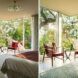 bedroom with two red chairs near glass walls
