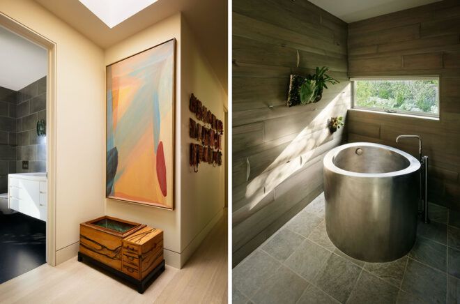 Hallway of art leading to bathroom with steel bathtub