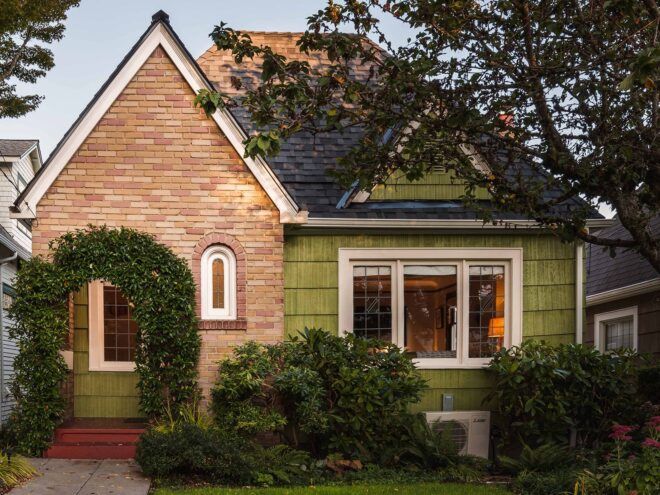 green and brick Tudor home