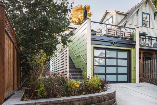 green and white garage with roof deck