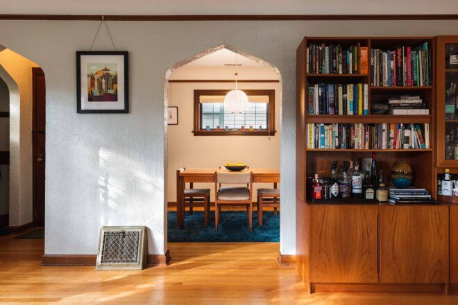 white arch doorway near bookshelves