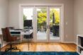 white desk facing glass wall leading to rooftop deck