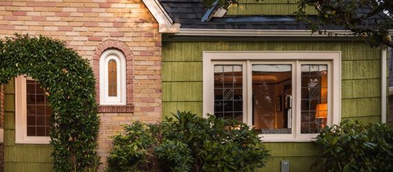 green and brick Tudor home
