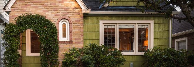 green and brick Tudor home