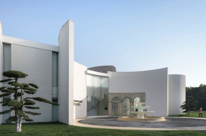 fountain in front of curved exterior wall of building