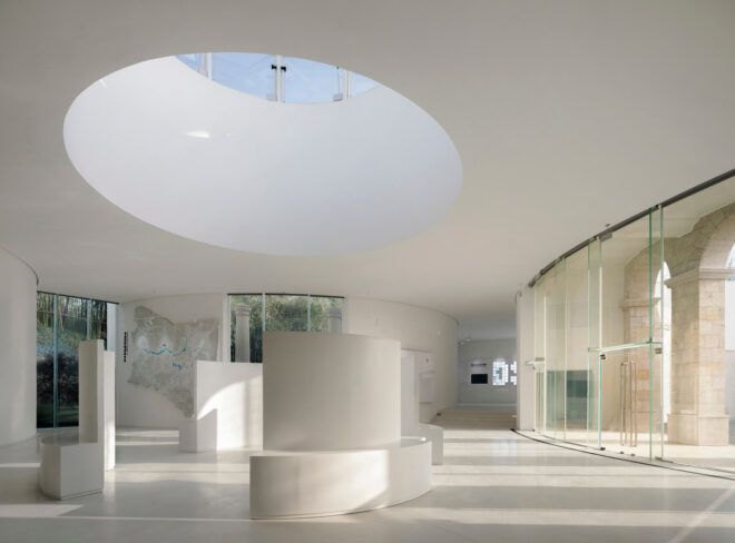 round skylight over all-white lobby in art hall