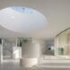 round skylight over all-white lobby in art hall