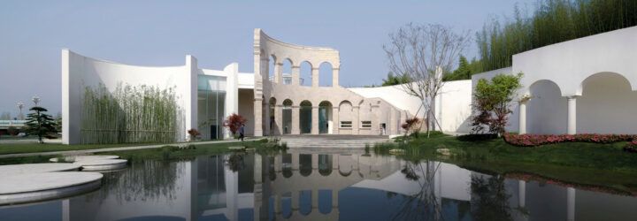 large white building with ancient Roman archwaysnear wetlands