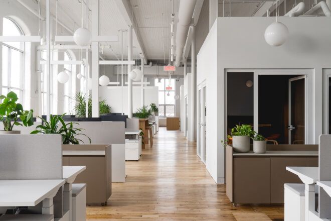 bright white office interior with dark gray desks