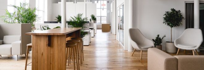 white office with wood tables and several plants