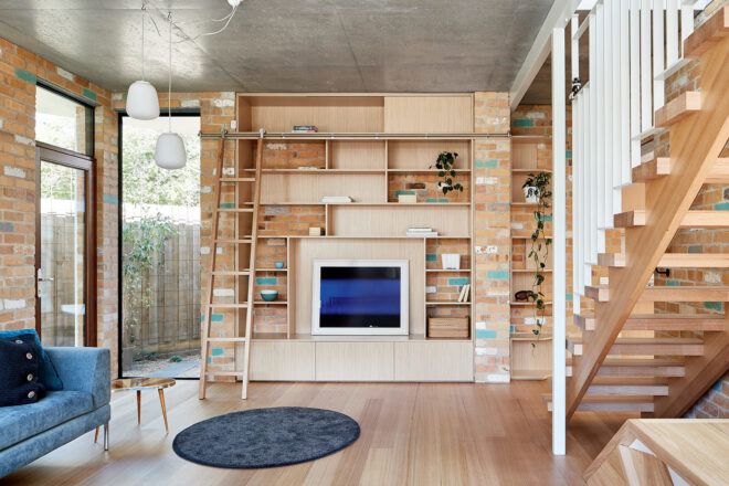 tan living area with built-in shelves on wall