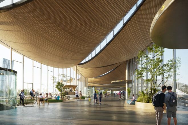 trees inside building with glass walls and curving wood ceiling
