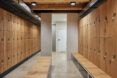 locker room with wood lockers and wood benches