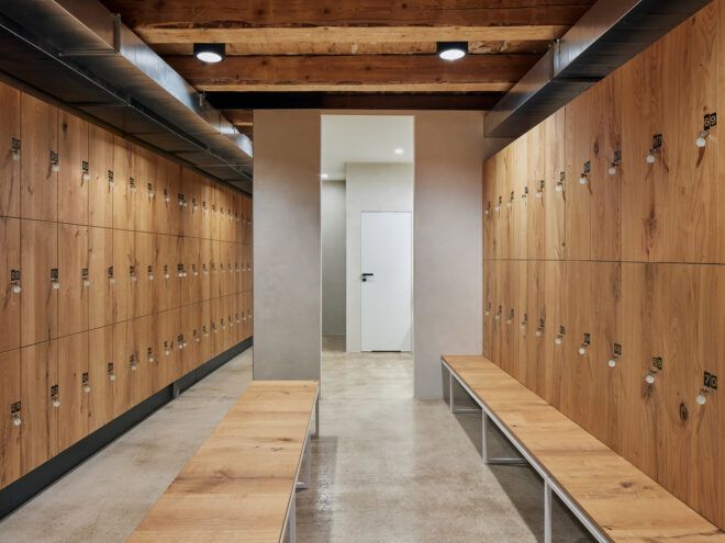 locker room with wood lockers and wood benches