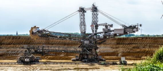 coal open mine with wind turbine in background