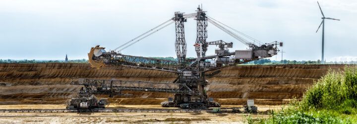 coal open mine with wind turbine in background