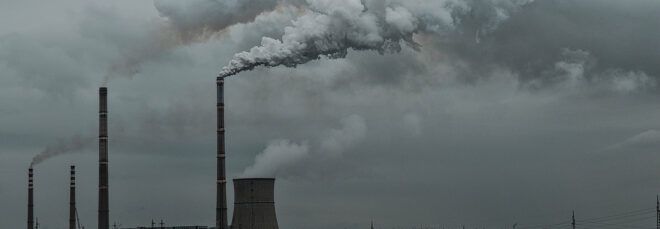 factory spewing emissions into gray skies