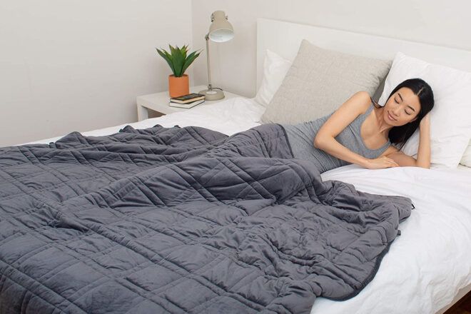 gray bamboo blanket on white bed