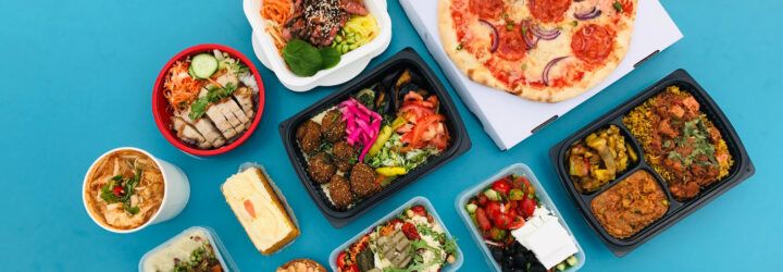 plastic takeout containers on blue background
