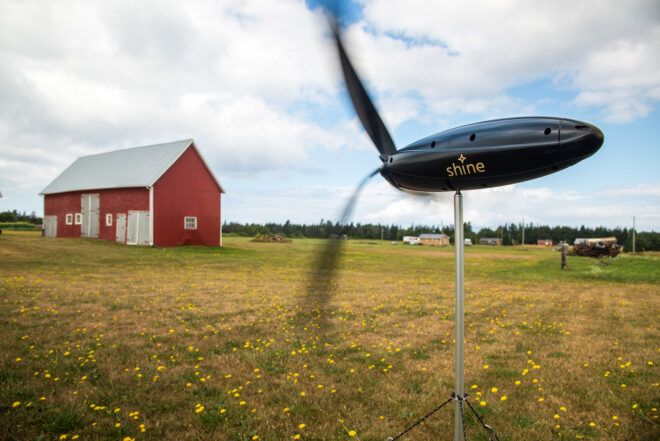 portable wind turbine on farm near red barn