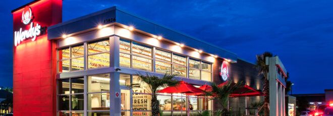 The exterior of a Wendy's restaurant at night.