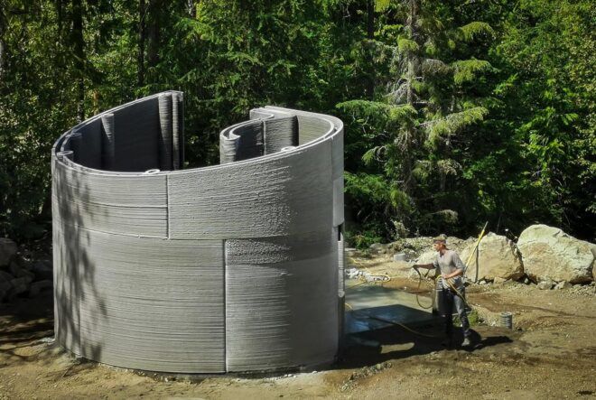 The curved concrete home being constructed.