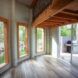 The interior of the home's foyer, showing wood accents and three large windows.