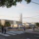A rendering of the streetview of the Olympic Village, showing a cross walk in front of several buildings that form a zigzagging roofline.