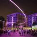 An outdoor courtyard at night, lit up by purple lights.