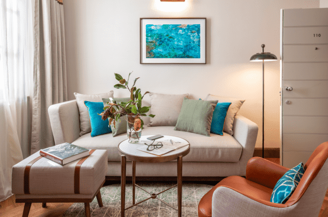 small white sofa with blue and green pillows