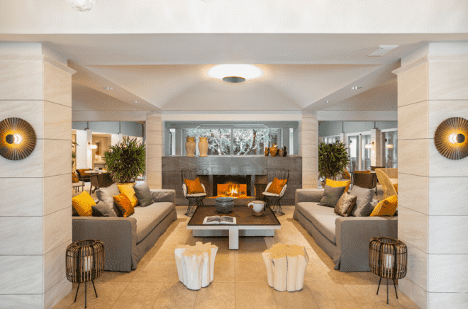 spa lobby with beige sofas near a fireplace