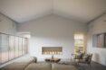 A living room with minimalist design, white walls, a fireplace and a beige sofa and chair.