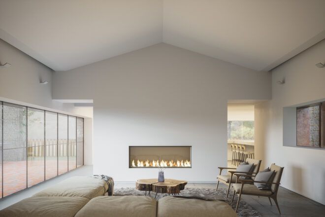 A living room with minimalist design, white walls, a fireplace and a beige sofa and chair.