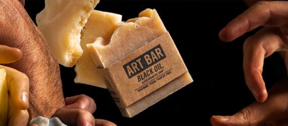 hands grabbing for natural bars of soap