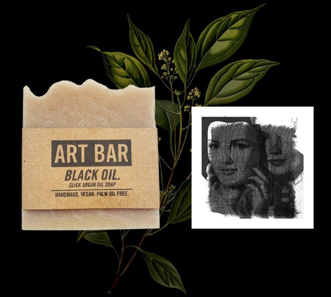 beige bar of soap next to art print with two faces