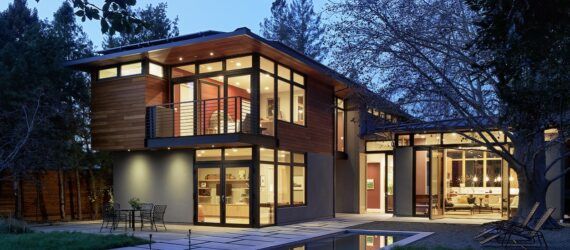A view of the home from the backyard at night.