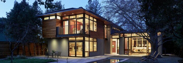 A view of the home from the backyard at night.