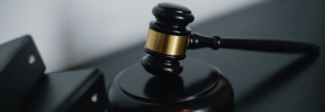 A gavel resting on a desk.