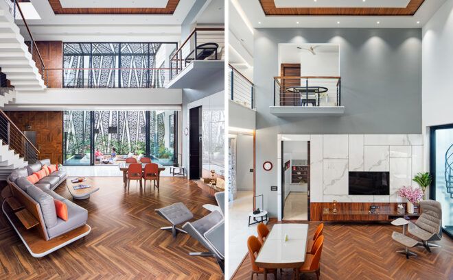 double height living room with chevron wood floors and large glass walls