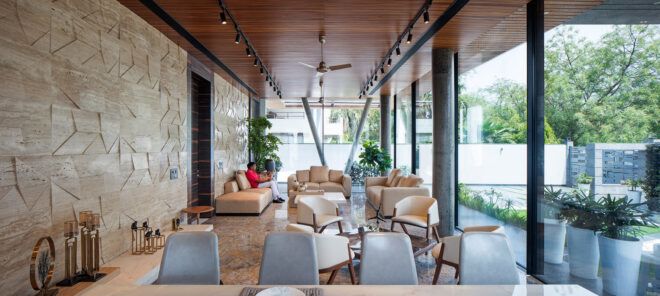 dining table and white chairs in room with wood ceilings and floors