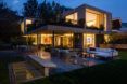 patio lounge outside tan home at dusk