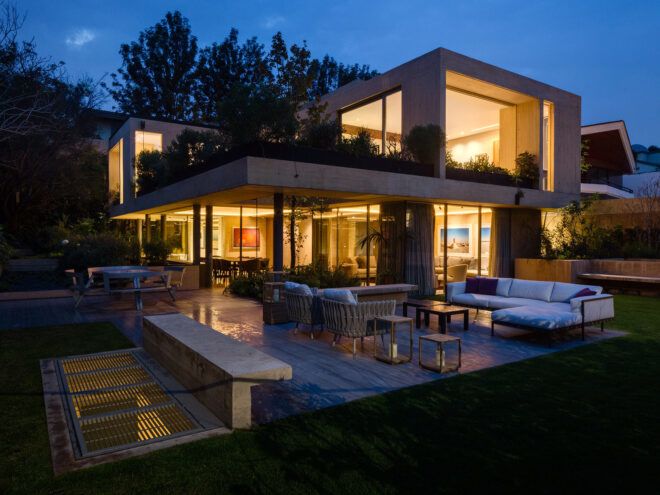 patio lounge outside tan home at dusk