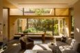 gray living room furniture near glass wall with garden views