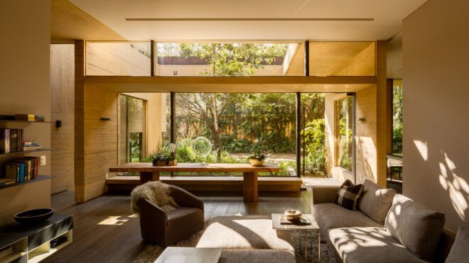 gray living room furniture near glass wall with garden views