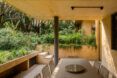 dining table near wall covered in plants
