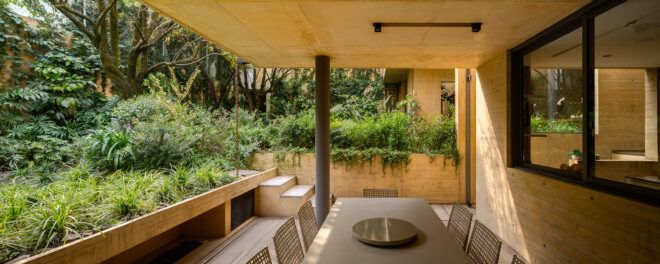 dining table near wall covered in plants
