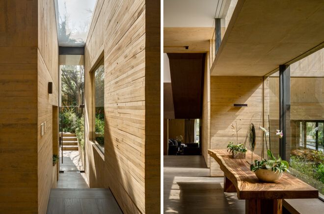 tan hallway with glass walls revealing garden views