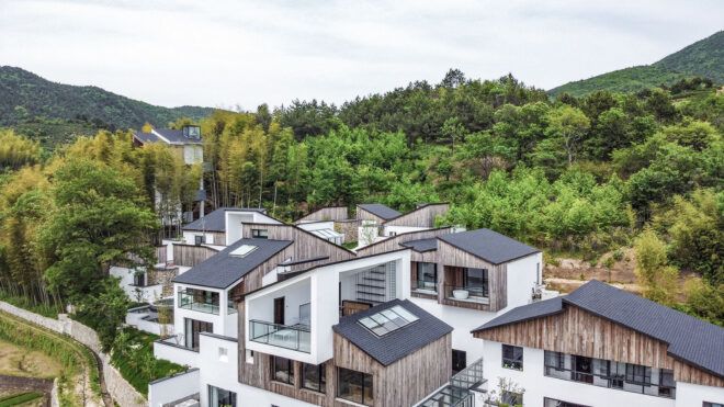 aerial view of wood and white homes in a forest