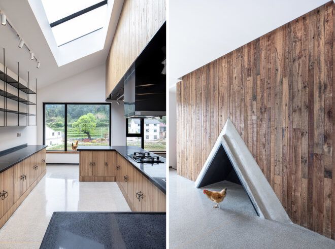 On the left, kitchen with wood cabinets and black counters. On the right, wood accent wall with triangular fireplace at the base