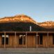 one-story wood building in front of mountains